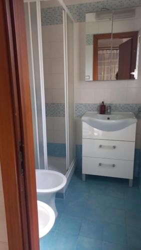 a bathroom with a sink and a shower and a toilet at La Casa Dei Nonni in Naples