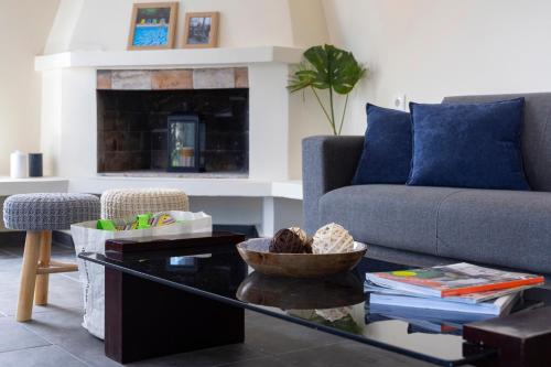 a living room with a couch and a coffee table at Sunny Sea House in Rafina