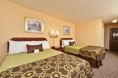 a hotel room with two beds in a room at Americas Best Value Inn San Jose in San Jose