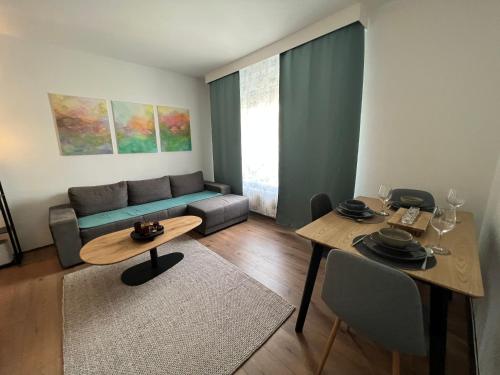 a living room with a couch and a table at Friendly Space Apartment in Graz
