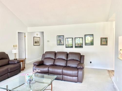 a living room with a couch and a glass table at Golf Front SFH, 3 BR, 2 BA, 4 beds, sleep 6 on Pinehurst #6 in Pinehurst