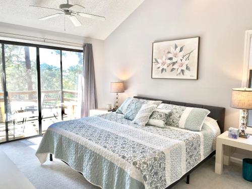 a bedroom with a bed and a large window at Golf Front SFH, 3 BR, 2 BA, 4 beds, sleep 6 on Pinehurst #6 in Pinehurst