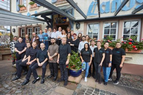 a group of people posing for a picture in front of a building at Hotel & Restaurant Burgschänke in Kaiserslautern