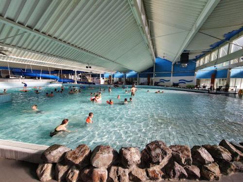 a group of people in a large swimming pool at Houseboat Kamperland in Kamperland