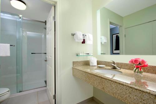 a bathroom with a sink and a shower at Residence Inn Colorado Springs South in Colorado Springs