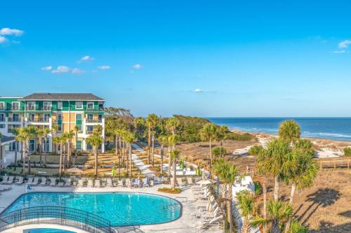an aerial view of a resort with a swimming pool and the ocean at Residence Inn by Marriott Jekyll Island in Jekyll Island