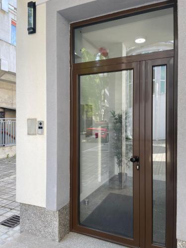 a wooden door on a building with a window at Morpheus apartmani in Sremska Mitrovica