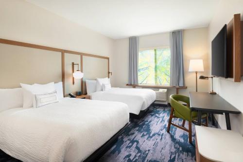 a hotel room with two beds and a desk at Fairfield Inn & Suites by Marriott Lexington East/I-75 in Lexington