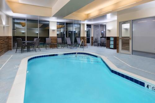 una piscina en un hotel con mesas y sillas en Fairfield Inn & Suites by Marriott Lexington East/I-75 en Lexington