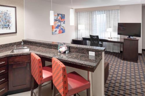 a hotel room with a kitchen and a living room at Residence Inn by Marriott Dallas Plano/Richardson in Plano