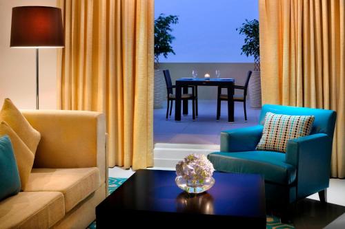 a living room with a couch and chairs and a table at Residence Inn by Marriott Manama Juffair in Manama