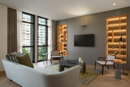 a living room with a couch and a tv at Marriott Executive Apartments Istanbul Fulya in Istanbul