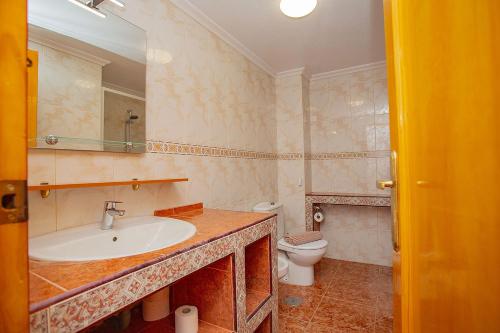 a bathroom with a sink and a toilet at 139 Lucias Beach Alicante Holiday in Torrevieja