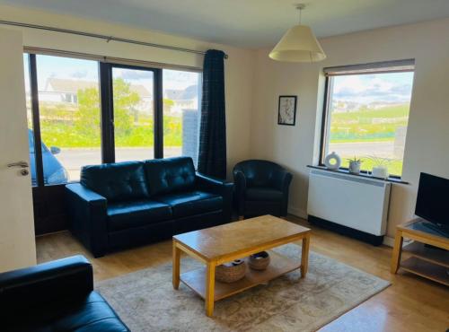 a living room with a couch and a coffee table at No. 6 Corran Meabh in Lahinch