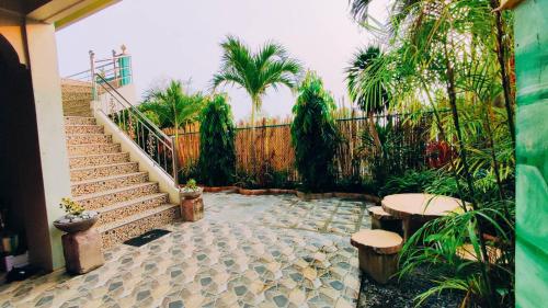 a patio with stairs and benches and a fence at Emshienell Beach Resort and Event Place in Zambales