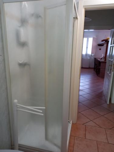 a glass door leading into a hallway with a tile floor at 4 giugno Ferrara in Ferrara