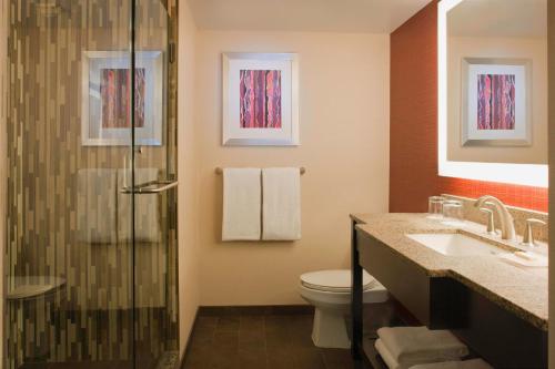 a bathroom with a shower and a toilet and a sink at Courtyard Los Angeles Sherman Oaks in Sherman Oaks