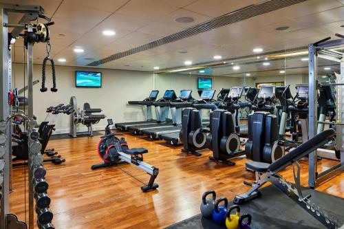 a gym with rows of treadms and cardio machines at London Marriott Hotel Canary Wharf in London