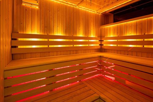 a wooden sauna with a bench in the middle at London Marriott Hotel Canary Wharf in London