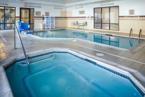 a swimming pool with blue water in a building at SpringHill Suites by Marriott Medford in Medford
