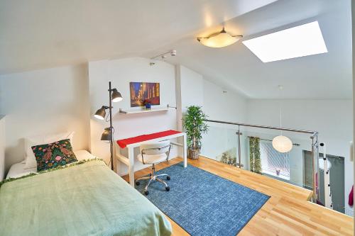 a bedroom with a bed and a desk in it at Staylong Hotell in Täby