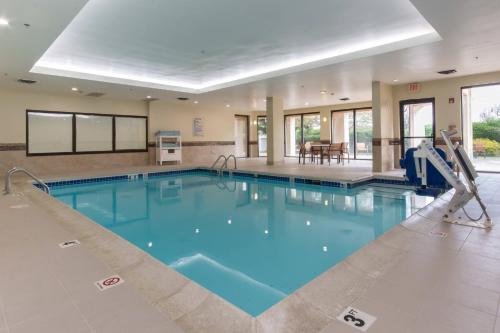 a large swimming pool with blue water at Courtyard by Marriott Charlotte Lake Norman in Huntersville
