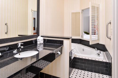 a bathroom with a sink and a tub at Fairfield Inn and Suites by Marriott Birmingham Pelham/I-65 in Pelham