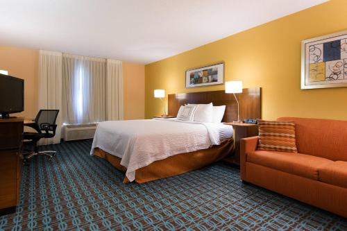 a hotel room with a bed and a chair at Fairfield Inn Orangeburg in Orangeburg