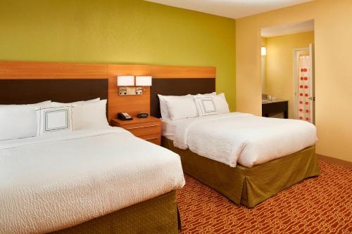 a hotel room with two beds in a room at TownePlace Suites by Marriott Saginaw in Saginaw