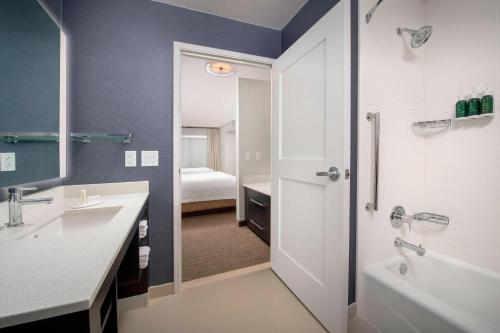 a bathroom with a shower and a sink and a tub at Residence Inn by Marriott Lubbock Southwest in Lubbock