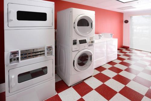a laundry room with two machines and a checkered floor at TownePlace Suites by Marriott Houston Galleria Area in Houston