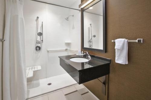 a bathroom with a sink and a shower at Fairfield Inn & Suites by Marriott Milwaukee Downtown in Milwaukee