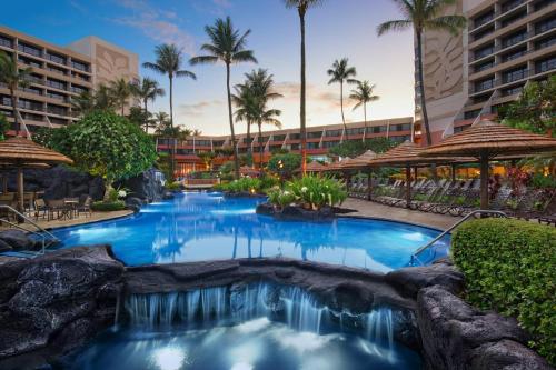 a swimming pool with a waterfall in a resort at Marriott's Maui Ocean Club - Lahaina & Napili Towers in Lahaina