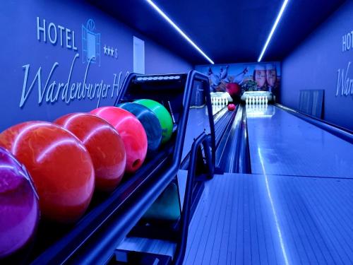 a bowling alley with balls on the lanes at Hotel Wardenburger Hof in Wardenburg