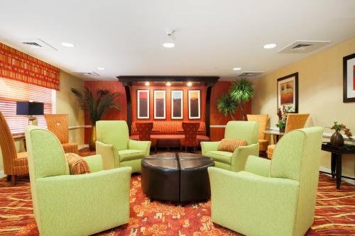 a waiting room with green chairs and a table at Residence Inn by Marriott Albuquerque North in Albuquerque