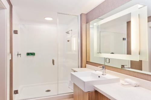 a bathroom with two sinks and a shower at SpringHill Suites by Marriott Montgomery Prattville/Millbrook in Millbrook