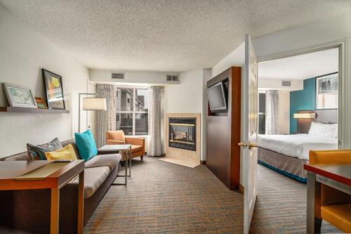 マッカレンにあるResidence Inn by Marriott McAllenのベッドとリビングルームが備わるホテルルームです。