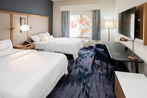 a hotel room with two beds and a desk at Fairfield Inn & Suites by Marriott Elizabethtown in Elizabethtown