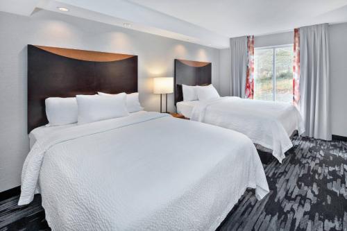 a hotel room with two beds and a window at Fairfield Inn & Suites by Marriott Marietta in Marietta