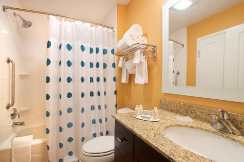 a bathroom with a sink and a toilet and a shower at TownePlace Suites by Marriott Dodge City in Dodge City