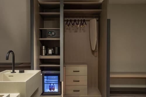 a kitchen with a refrigerator and a sink at AC Hotel by Marriott Downtown Los Angeles in Los Angeles