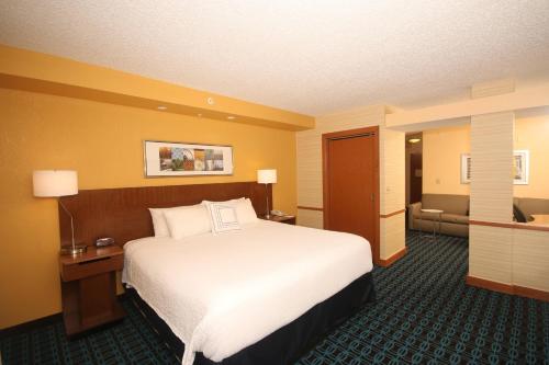 a hotel room with a large bed and a couch at Fairfield Inn & Suites by Marriott Aiken in Aiken