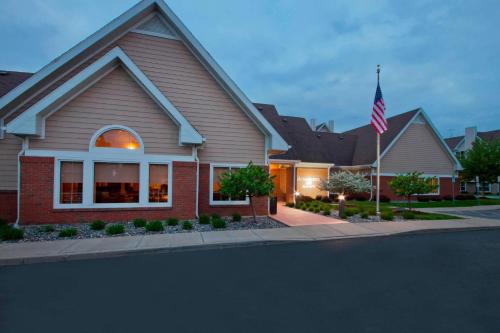 a house with an american flag in front of it at Residence Inn by Marriott Buffalo Galleria Mall in Cheektowaga