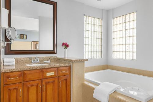 a bathroom with a tub and a large mirror at Marriott's Desert Springs Villas I in Palm Desert