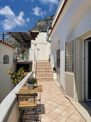 a patio with a table and chairs on a balcony at Casa Piccina in Praiano
