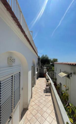 a patio with chairs and an umbrella on a building at Casa Piccina in Praiano