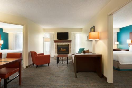 a hotel room with a bed and a fireplace at Residence Inn Corpus Christi in Corpus Christi