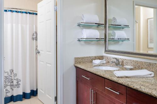 a bathroom with a sink and a mirror at Residence Inn Appleton in Appleton