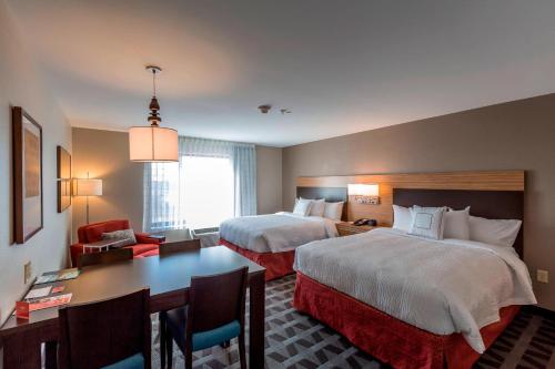 a hotel room with two beds and a desk at TownePlace Suites by Marriott Hopkinsville in Hopkinsville