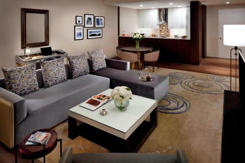 a living room with a couch and a table at Marriott Executive Apartments Downtown, Abu Dhabi in Abu Dhabi